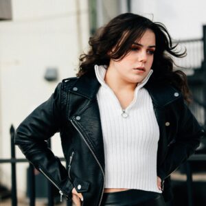 A woman in a leather skirt and a black jacket